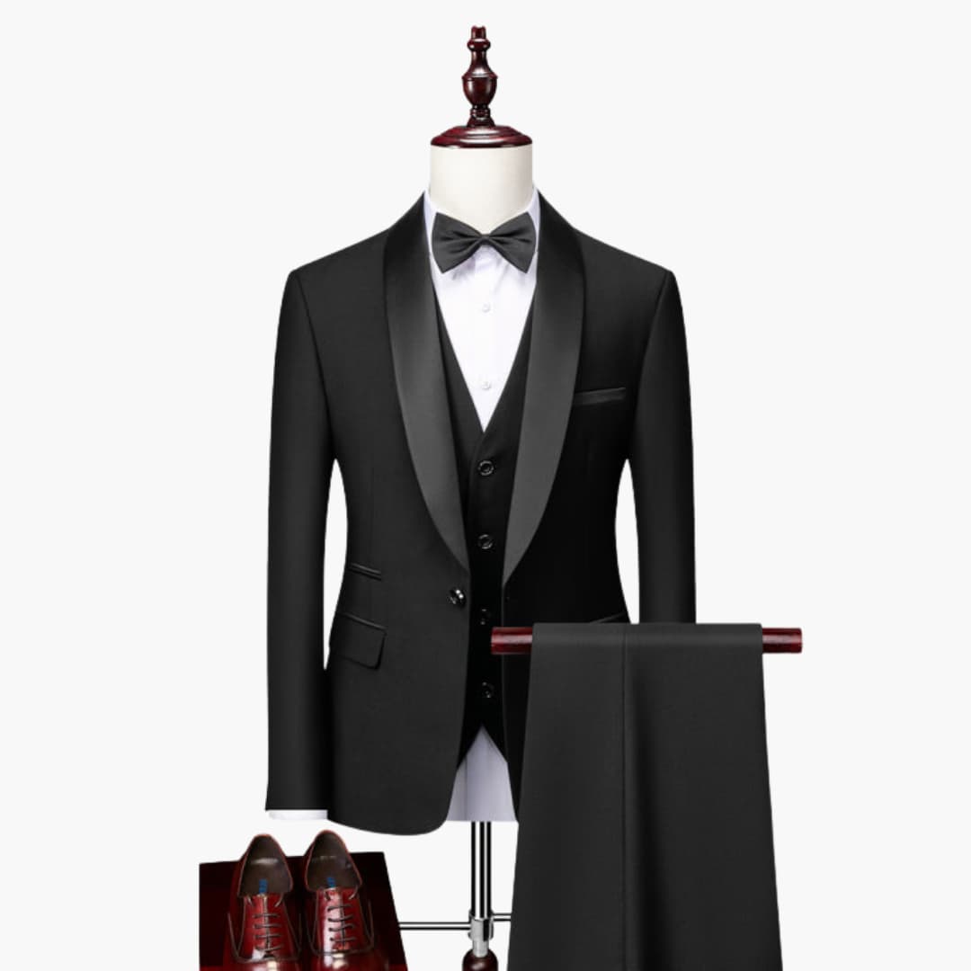 Men's three-piece tuxedo set by Wilfred Smith: black shawl-collar jacket, vest, white shirt, bow tie; red shoes shown.