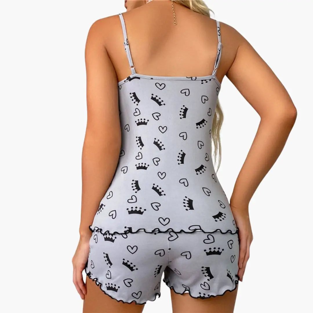 Women's sleeveless pajama set in light gray with crown and heart prints; top and shorts feature ruffled hems