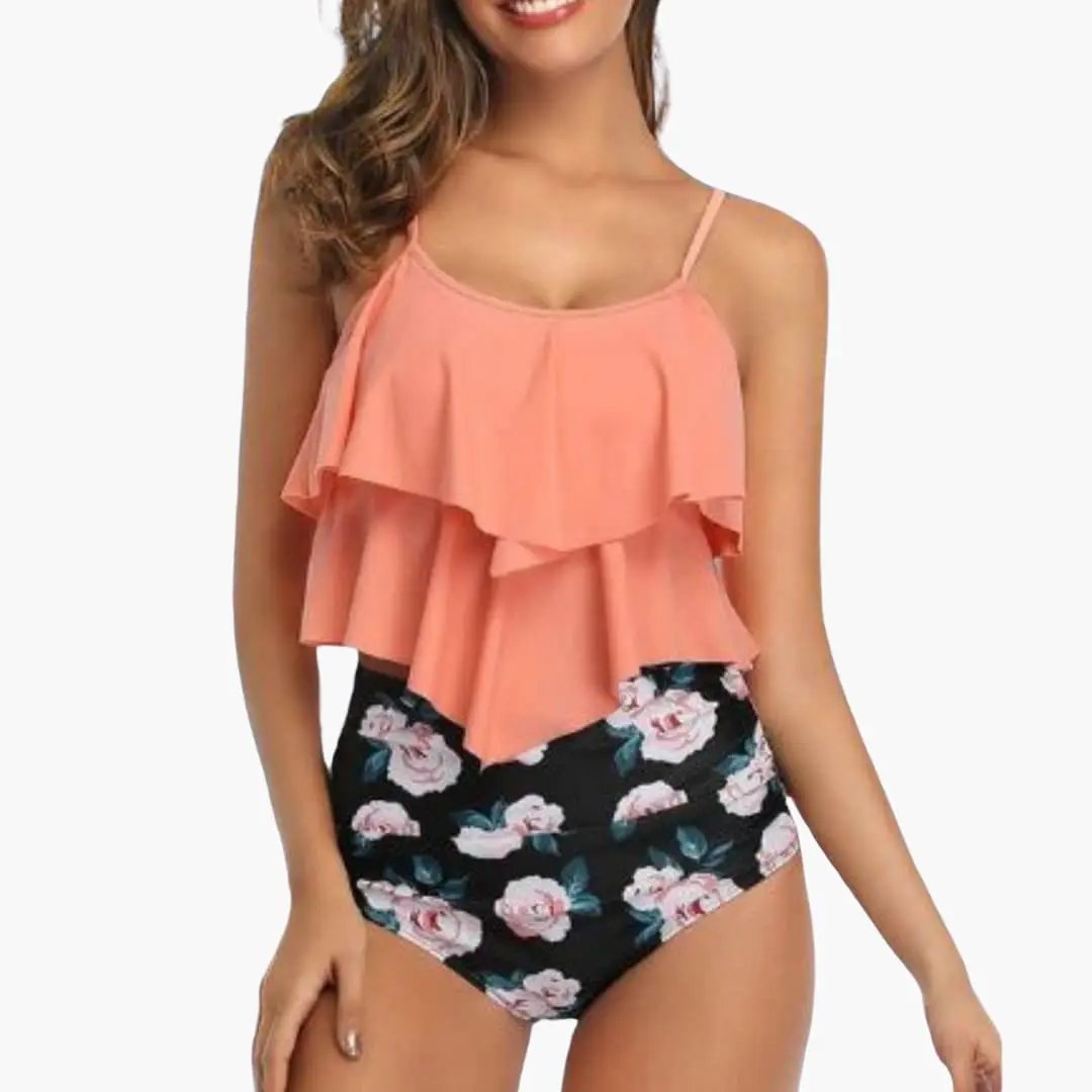 Two-piece women's tankini set with peach ruffled top and black floral-rose bottom.