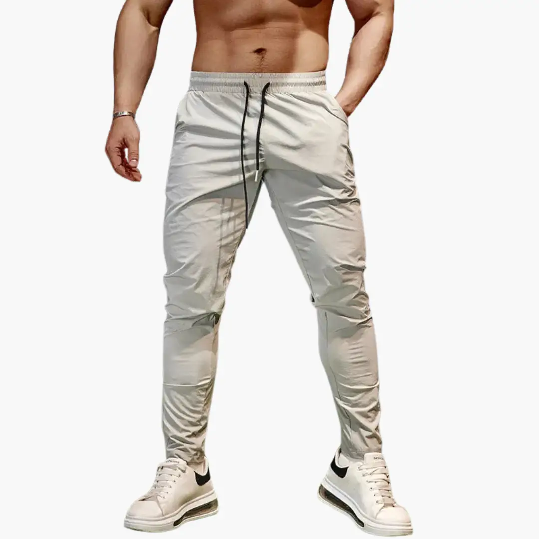 Men's jogging pants with elastic waistband and drawstring in light gray.