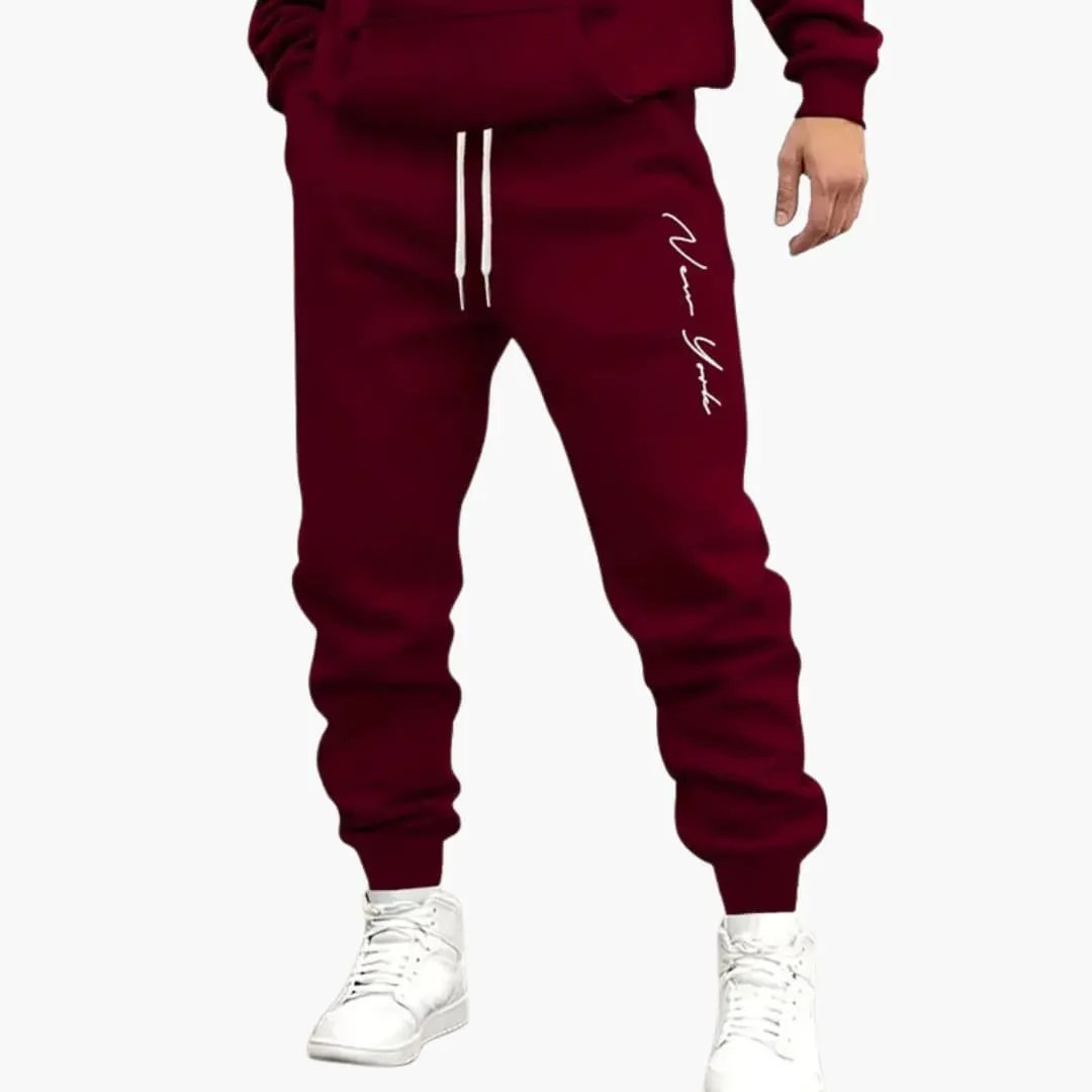 Men's jogging pants in burgundy with drawstring waist and cuffed hems.