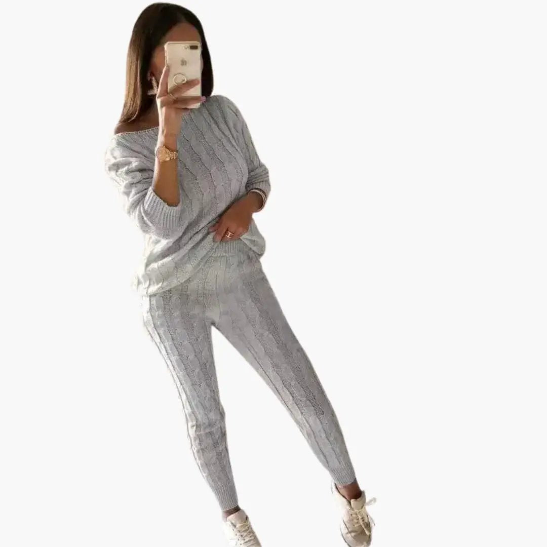 Women's knit two-piece set by Wilfred Smith in gray with cable knit pattern, long-sleeve top and elastic waist pants.