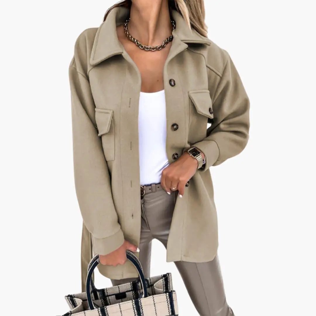 Women’s long beige jacket with button front and chest pockets.