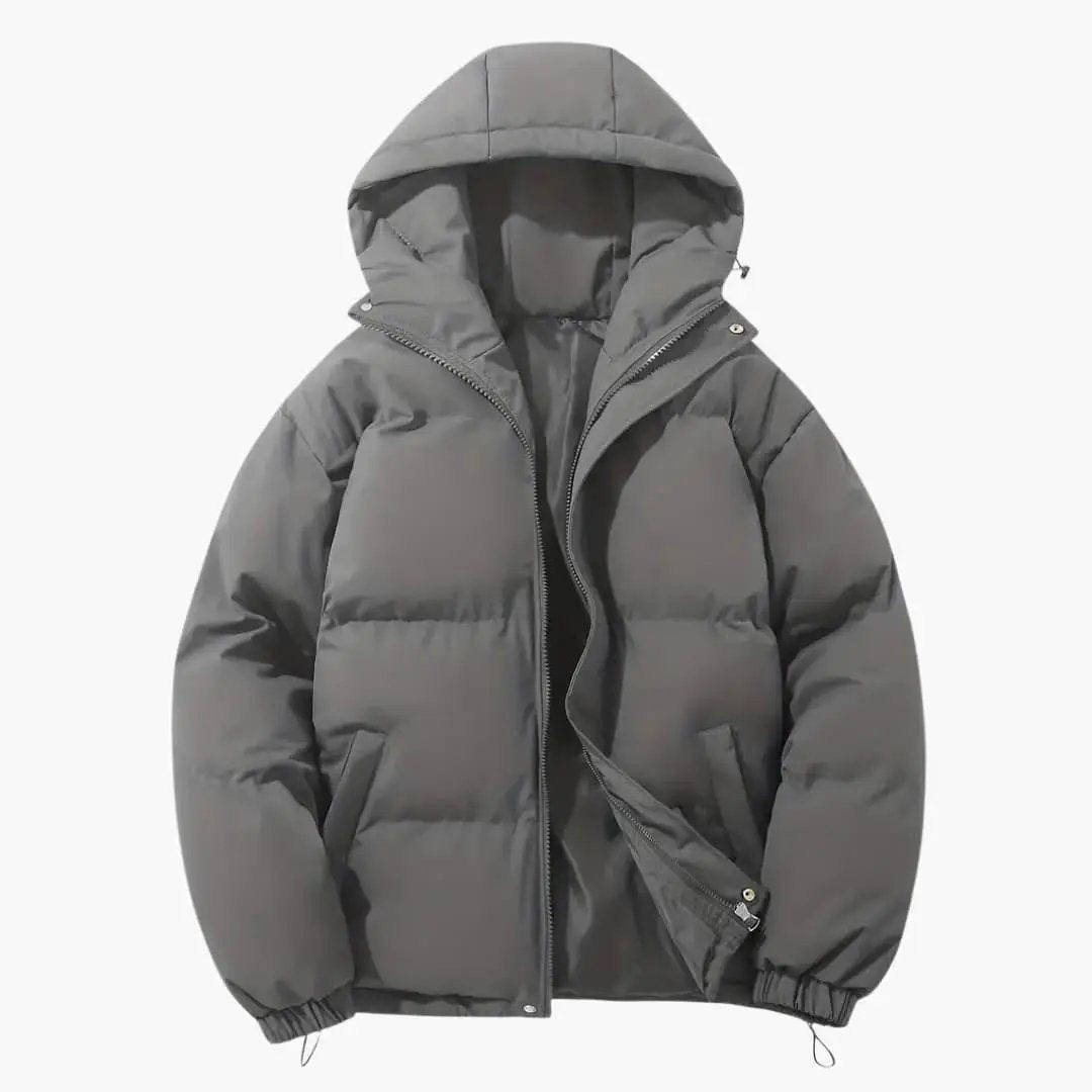 Women's gray puffer hooded jacket with front zipper, zip pockets and visible exterior stitching