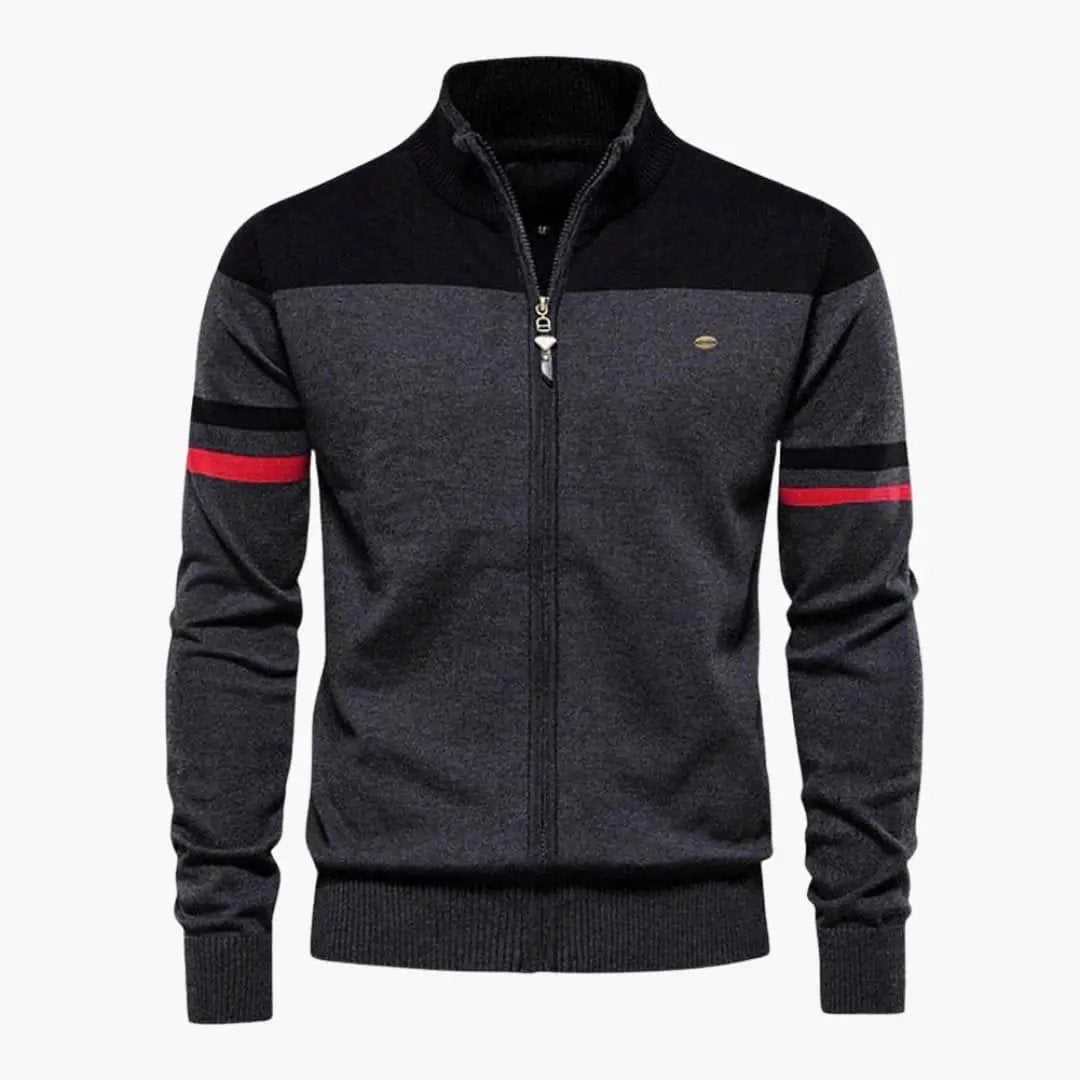 Men's zip-up cardigan with ribbed hem by Wilfred Smith; charcoal grey body with black yoke and red sleeve stripes.