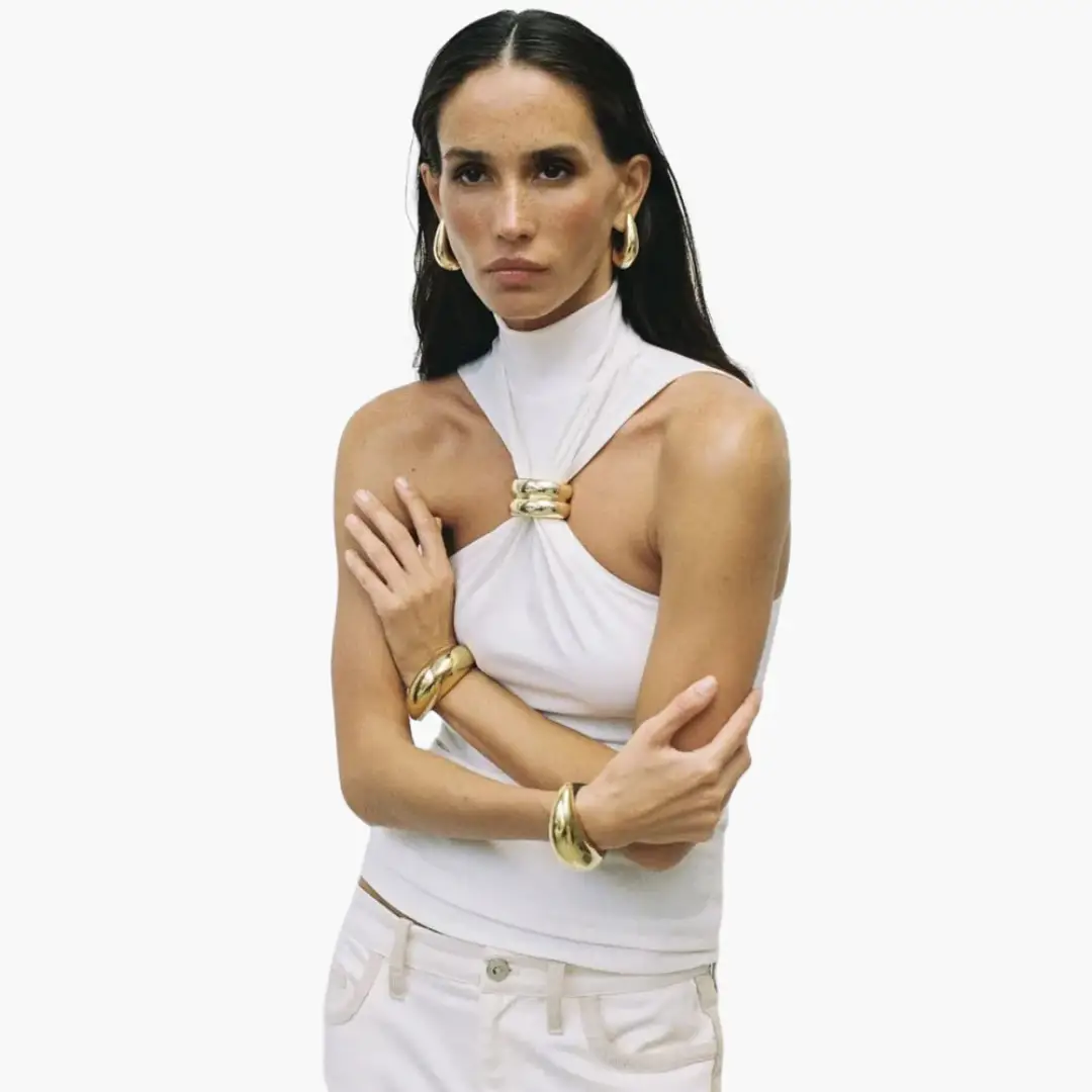 Chic white high-neck halter top with gold-tone accent ring at center