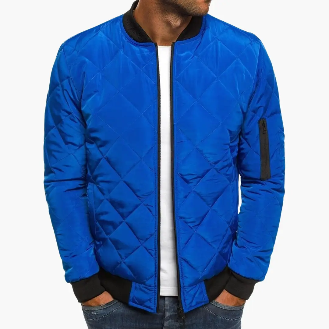 Men's blue quilted bomber jacket with front zipper, black rib cuffs, and zip arm pocket.
