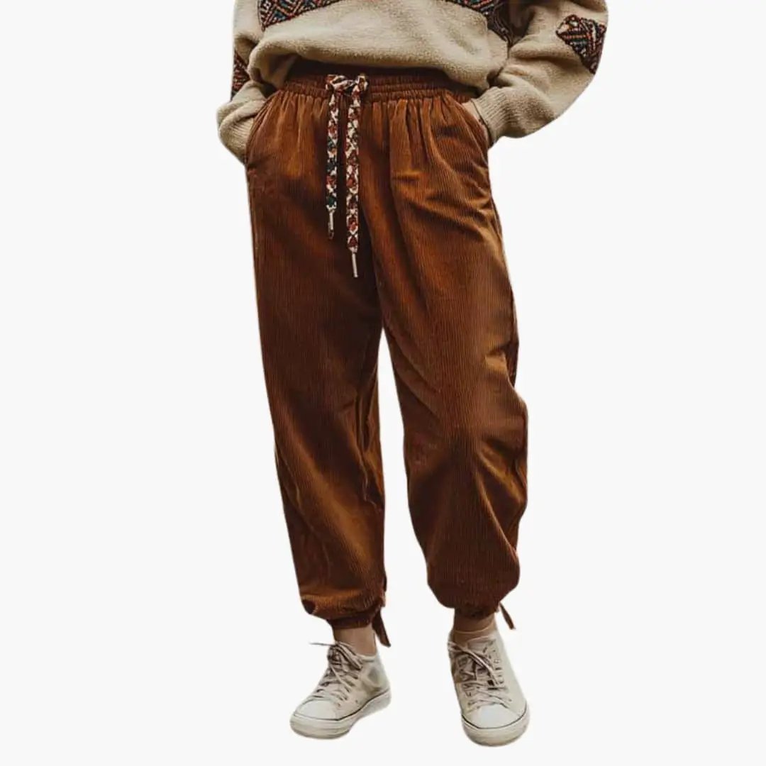 Women's corduroy pants with waistband and side pockets in brown, with drawstring waist and cuffed ankles.