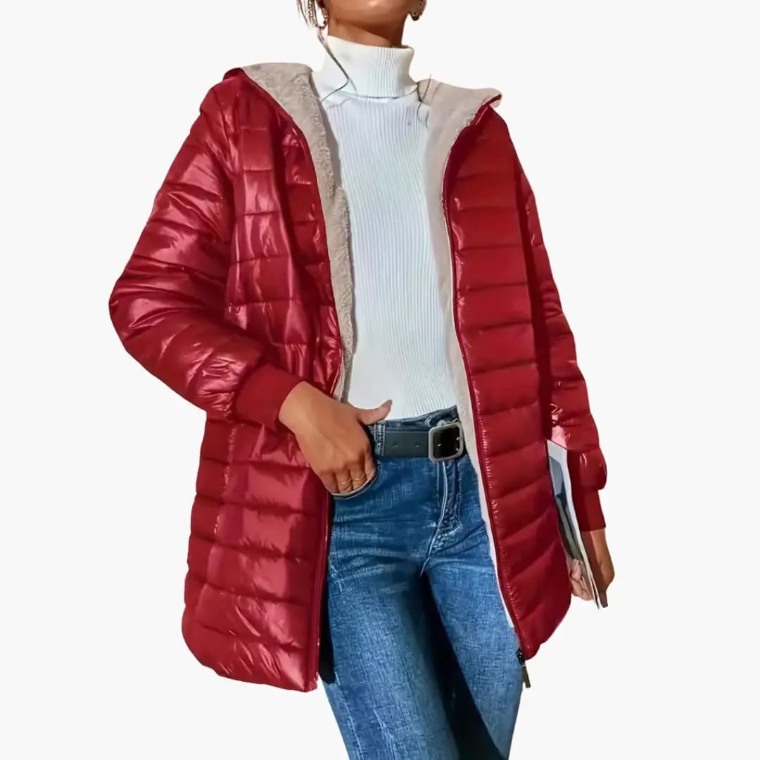 Women's red puffer coat with hood and zipper on a model wearing blue jeans.