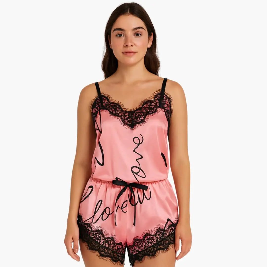 Women's satin pajama set by Wilfred Smith with pink spaghetti-top and lace-trim printed shorts.