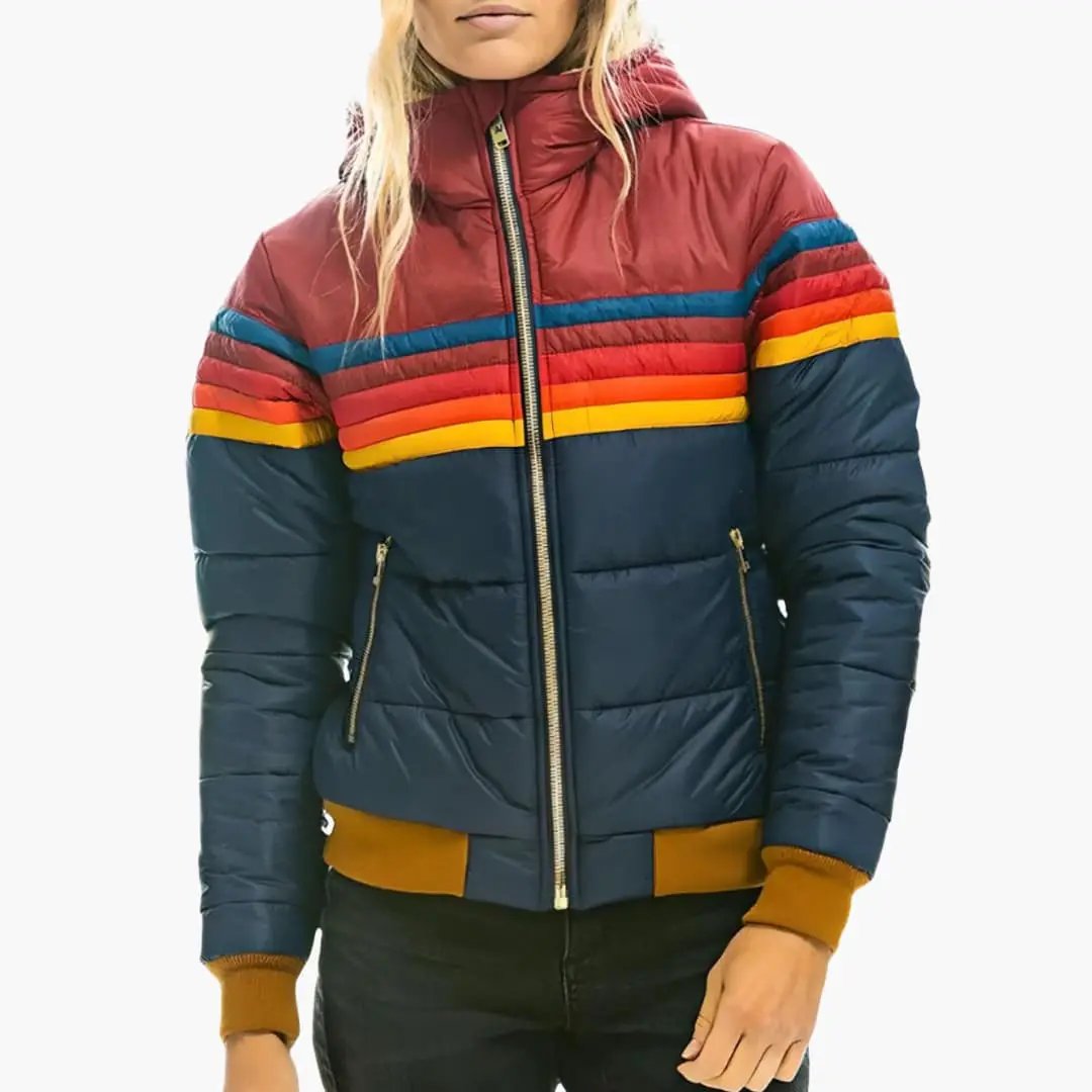 Women's padded hooded jacket in navy with rainbow stripes across the chest and sleeves, gold front zipper