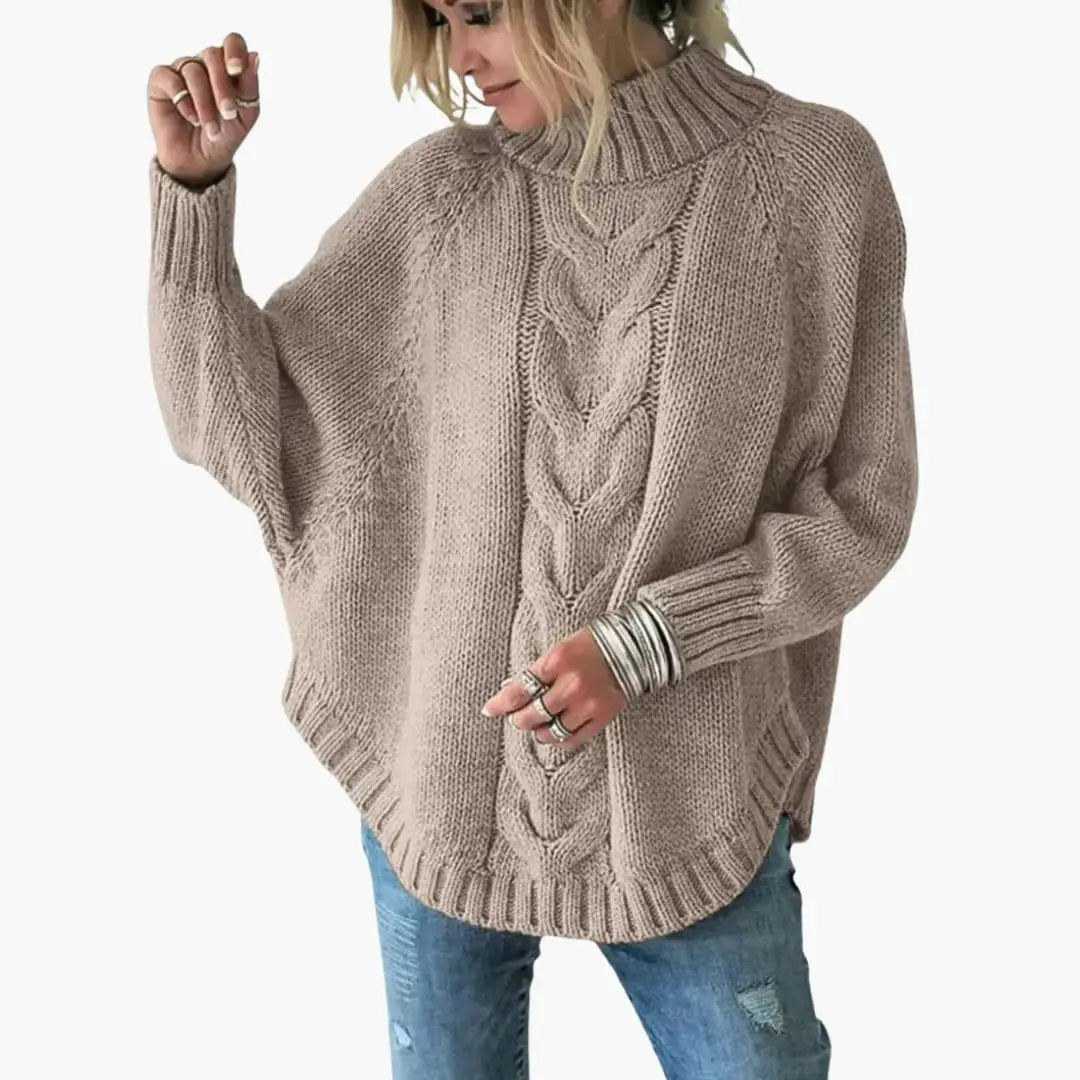 Women's taupe chunky knit sweater with a cable-front panel and oversized fit.