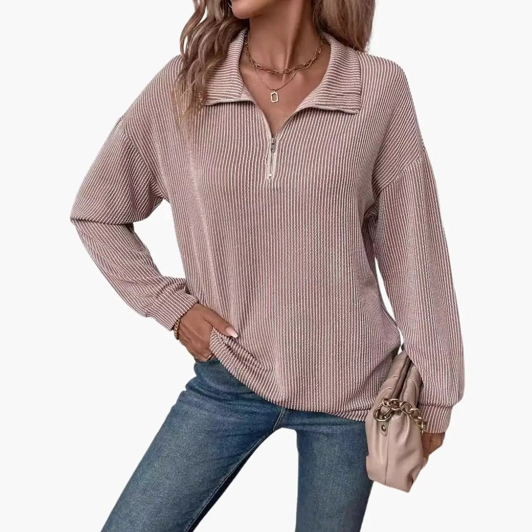 Women's striped knit pullover with half-zip in pink, Wilfred Smith, paired with blue jeans and a beige handbag.