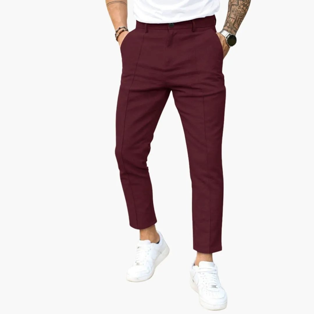 Men's burgundy pants with belt loops and a straight leg fit