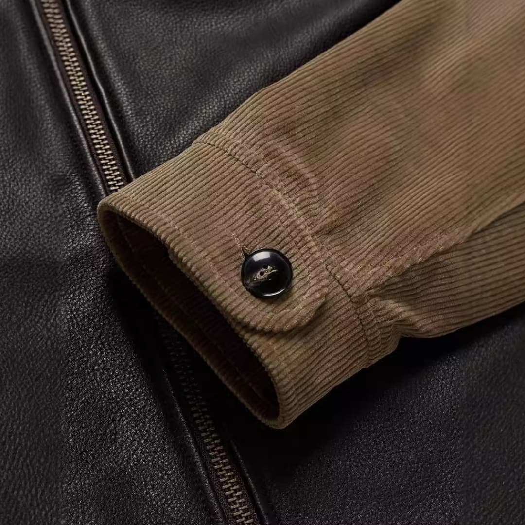 Men's jacket by Wilfred Smith with black leather body and brown corduroy sleeve cuff, zipper
