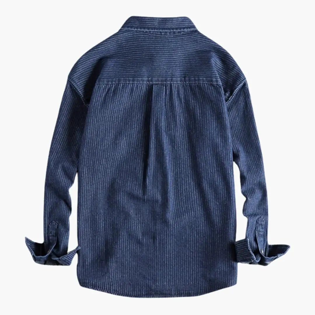 Men's utility shirt by Wilfred Smith, blue denim with snap-button closure and rolled cuffs.