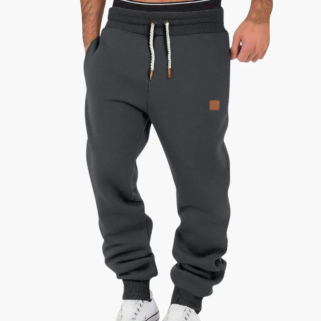 Men's jogging pants by Wilfred Smith in charcoal gray with pockets and drawstring waistband
