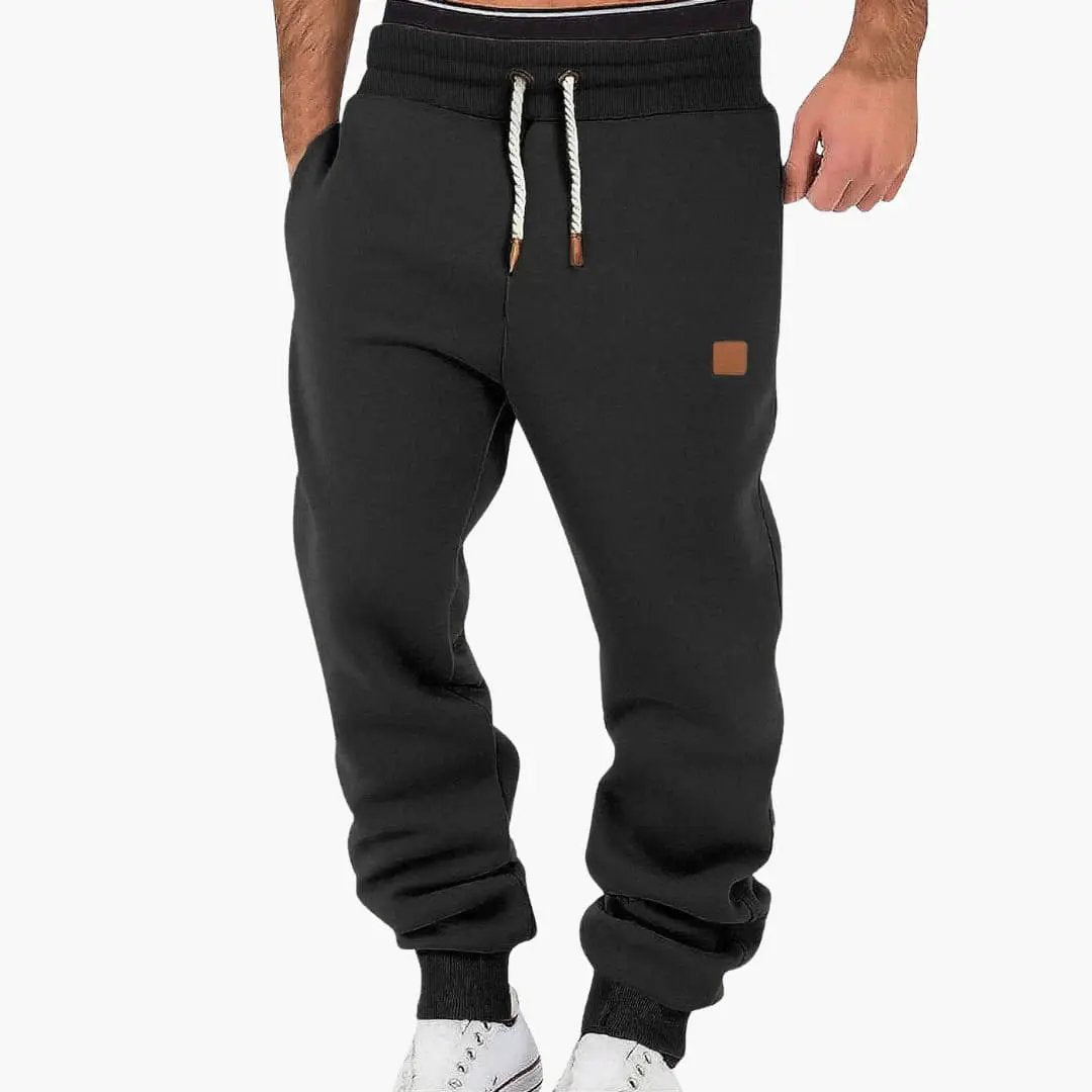 Men's jogging pants with pockets and drawstring waistband, black with cuffed ankles by Wilfred Smith