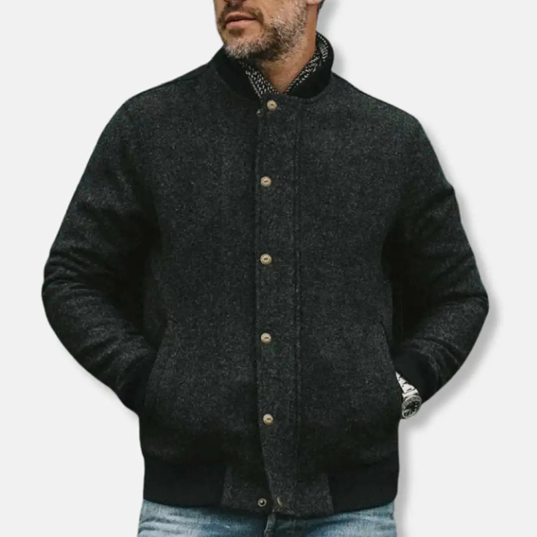Men’s bomber jacket by Wilfred Smith, dark charcoal textured wool with button closure and ribbed hem.