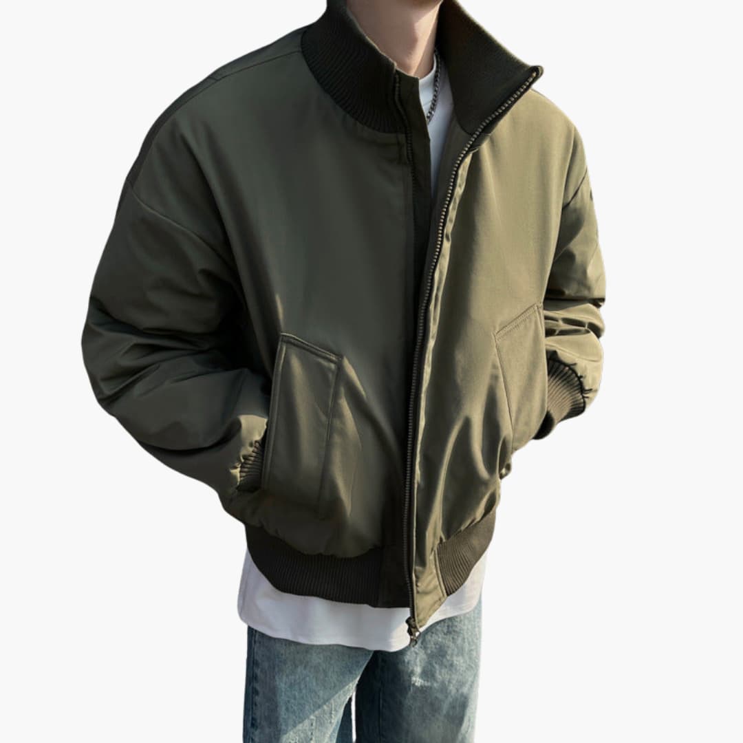 Men's bomber jacket in olive with high collar, black ribbed cuffs and hem, front zip and side pockets.
