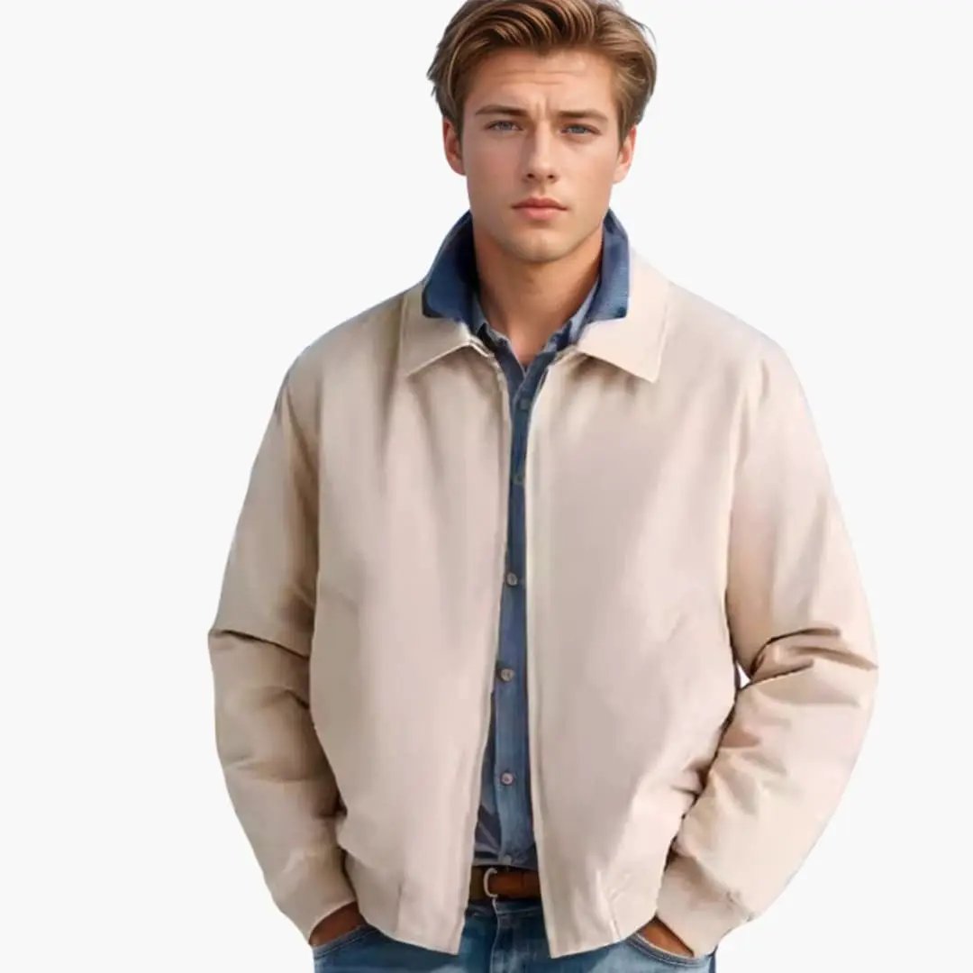 Men’s beige bomber jacket with front zip and classic collar, styled over a blue denim shirt.