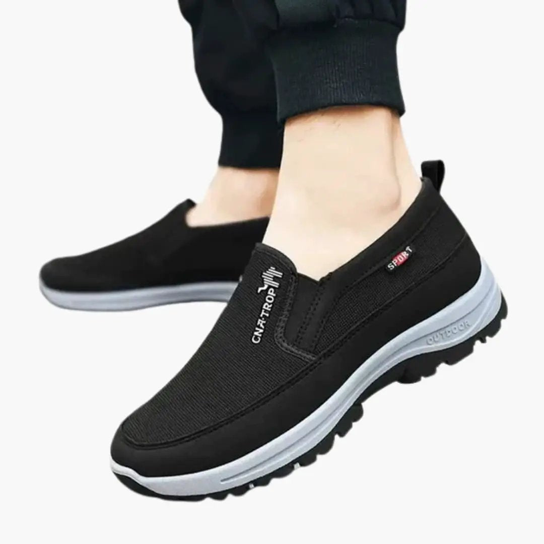 Men's orthopedic sneakers by Wilfred Smith, black slip-on with textured gray sole.