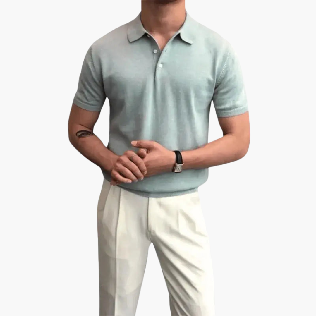 Men’s polo shirt in light blue with collar and short sleeves, paired with white pants.