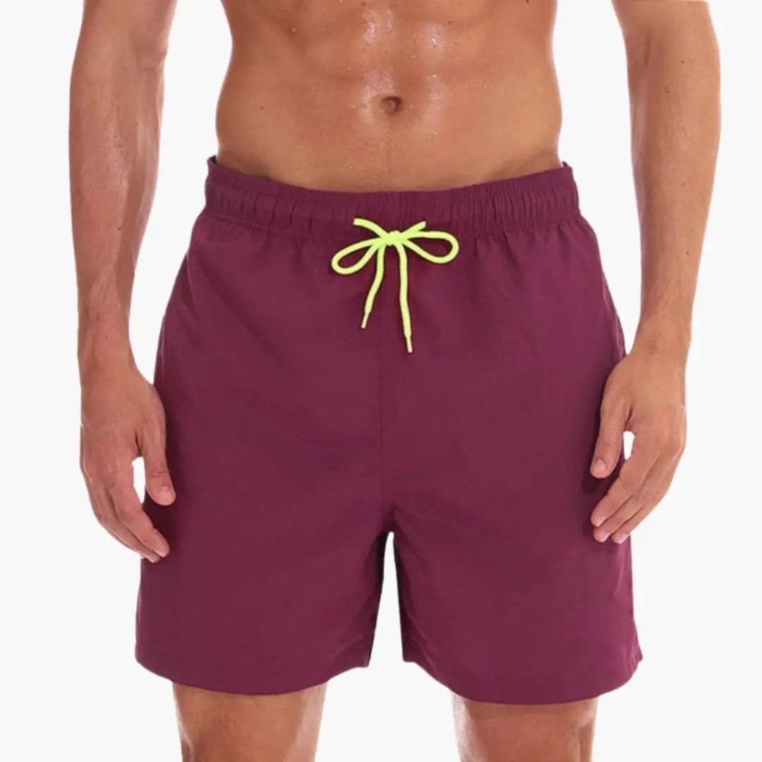 Men’s jogger shorts in burgundy with elastic waistband and neon yellow drawstring