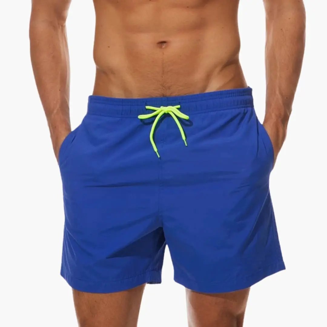 Men’s jogger shorts in blue with elastic waistband, neon green drawstring, inner lining