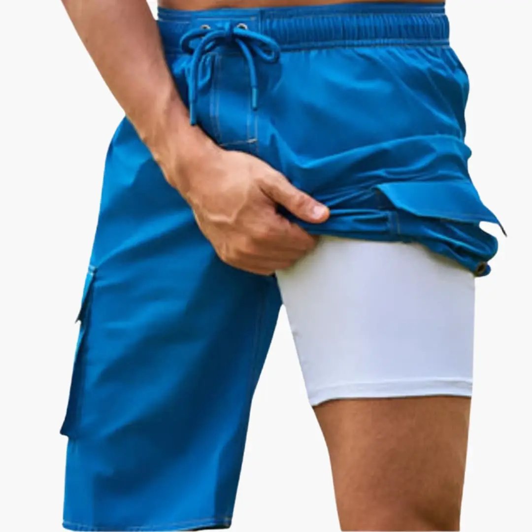 Men's stretch swim boardshorts in blue with inner lining, mid-length, drawstring waist, and side cargo pocket.
