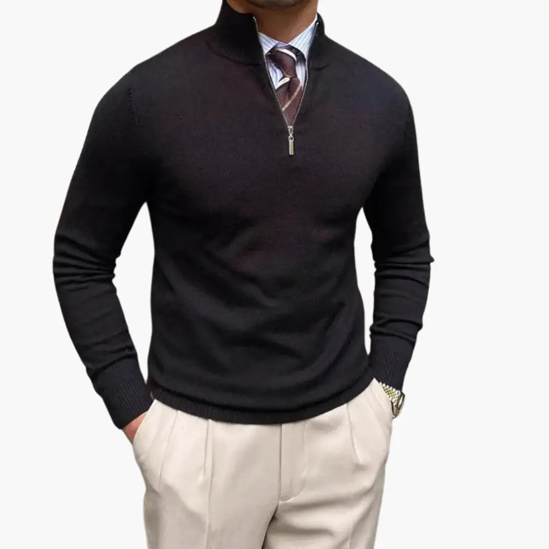 Men’s black half-zip jumper with stand collar and ribbed hem, worn with beige trousers.