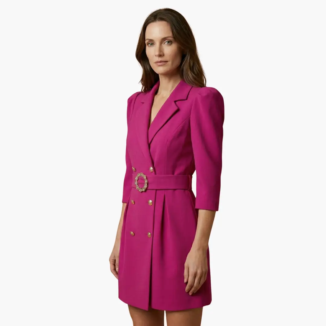 Women’s blazer dress in magenta with notched collar, gold button front, and decorative belt buckle.