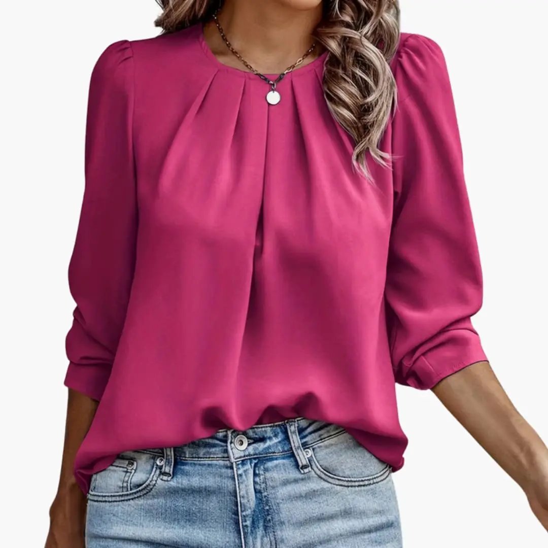 Women’s blouse with pleated puff sleeves in magenta, tucked into jeans