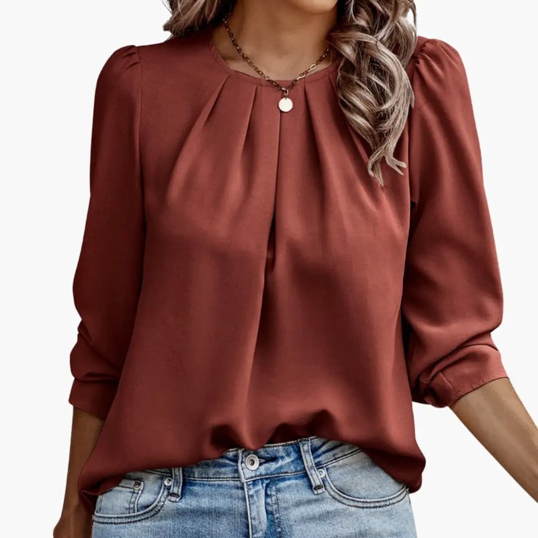 Women’s Blouse with Pleated Puff Sleeves in rust color, tucked into denim jeans