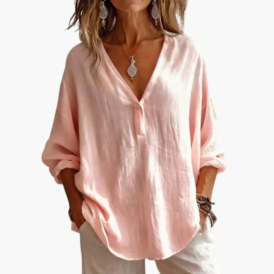 Women's pink linen blouse by Wilfred Smith with a v-neck button placket and rolled sleeves