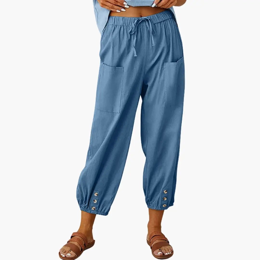 Women's blue casual pants with drawstring, side pockets, and cuffed ankles with buttons