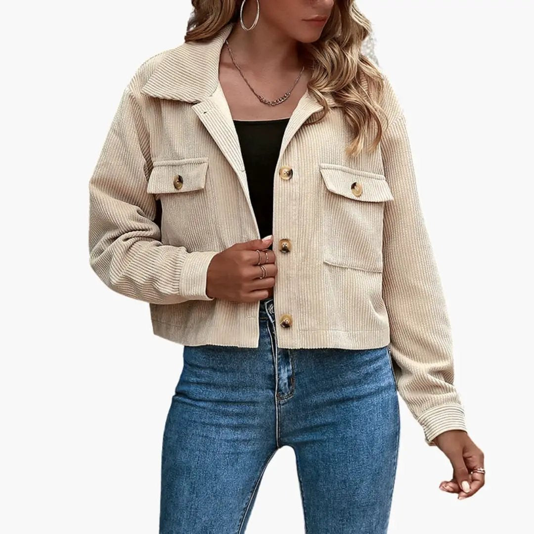 Women’s beige corduroy trucker jacket with lapel collar and front flap pockets.