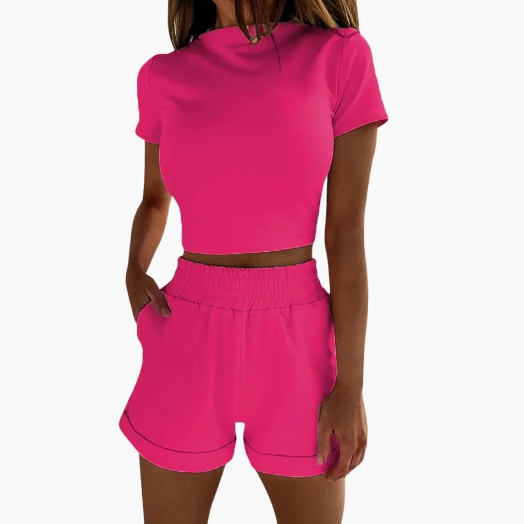 Women's crop top and shorts two-piece set in bright pink with elastic waistband