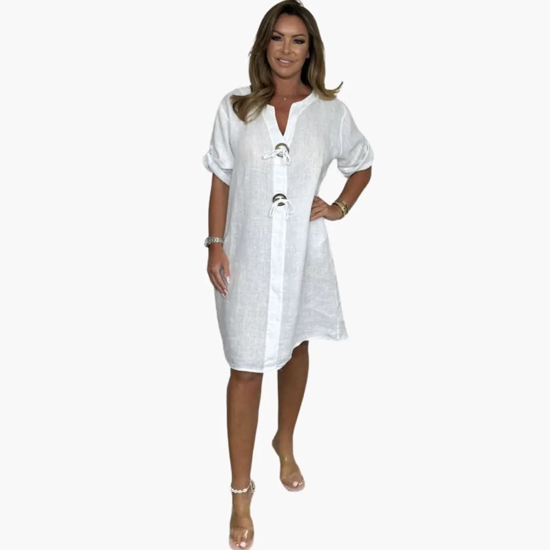 Women's white linen dress with long sleeves, lace-up front, knee-length.