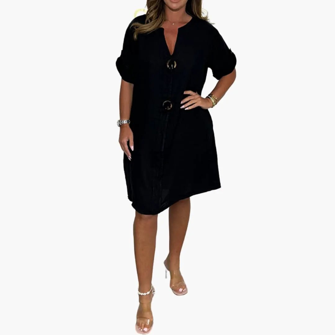 Women’s dress by Wilfred Smith, black knee-length with long sleeves and front ring closures