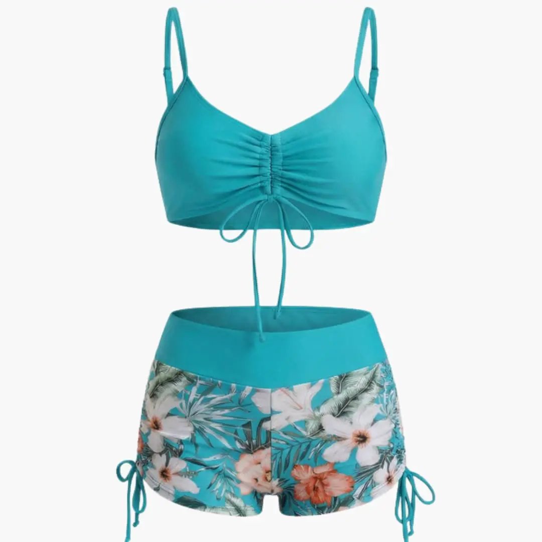 Women's high-waisted turquoise two-piece bikini set with ruched top and floral-print bottoms