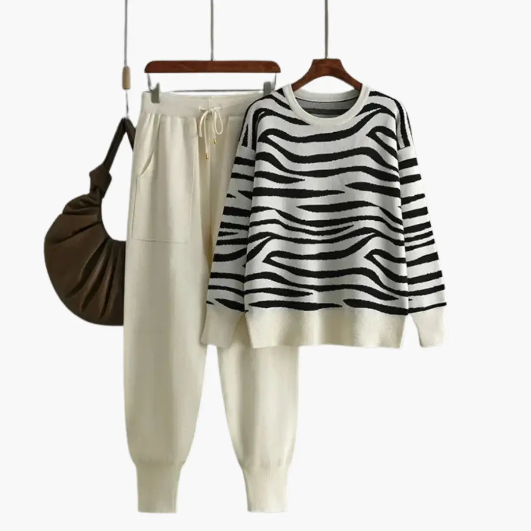Women’s two-piece knit lounge set by Wilfred Smith: zebra-striped sweater and cream joggers.