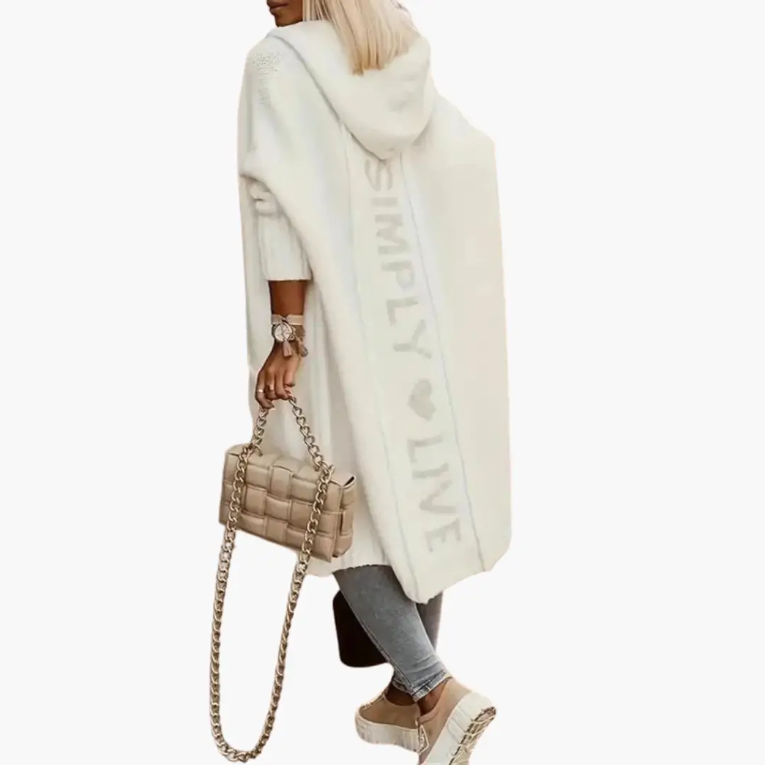 Women’s long hooded knitted cardigan by Wilfred Smith in white with open front and side pockets.