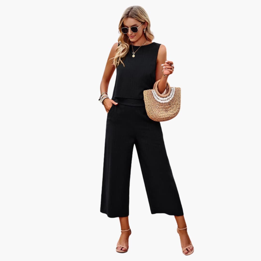 Women’s black one-piece jumpsuit with wide-leg pants worn by a model