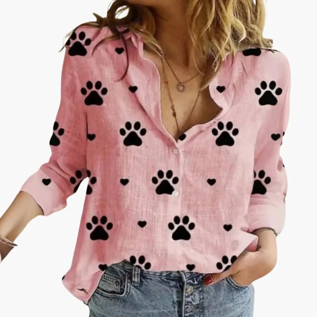 Women's pink long-sleeve blouse with black paw print pattern, button-front, relaxed fit