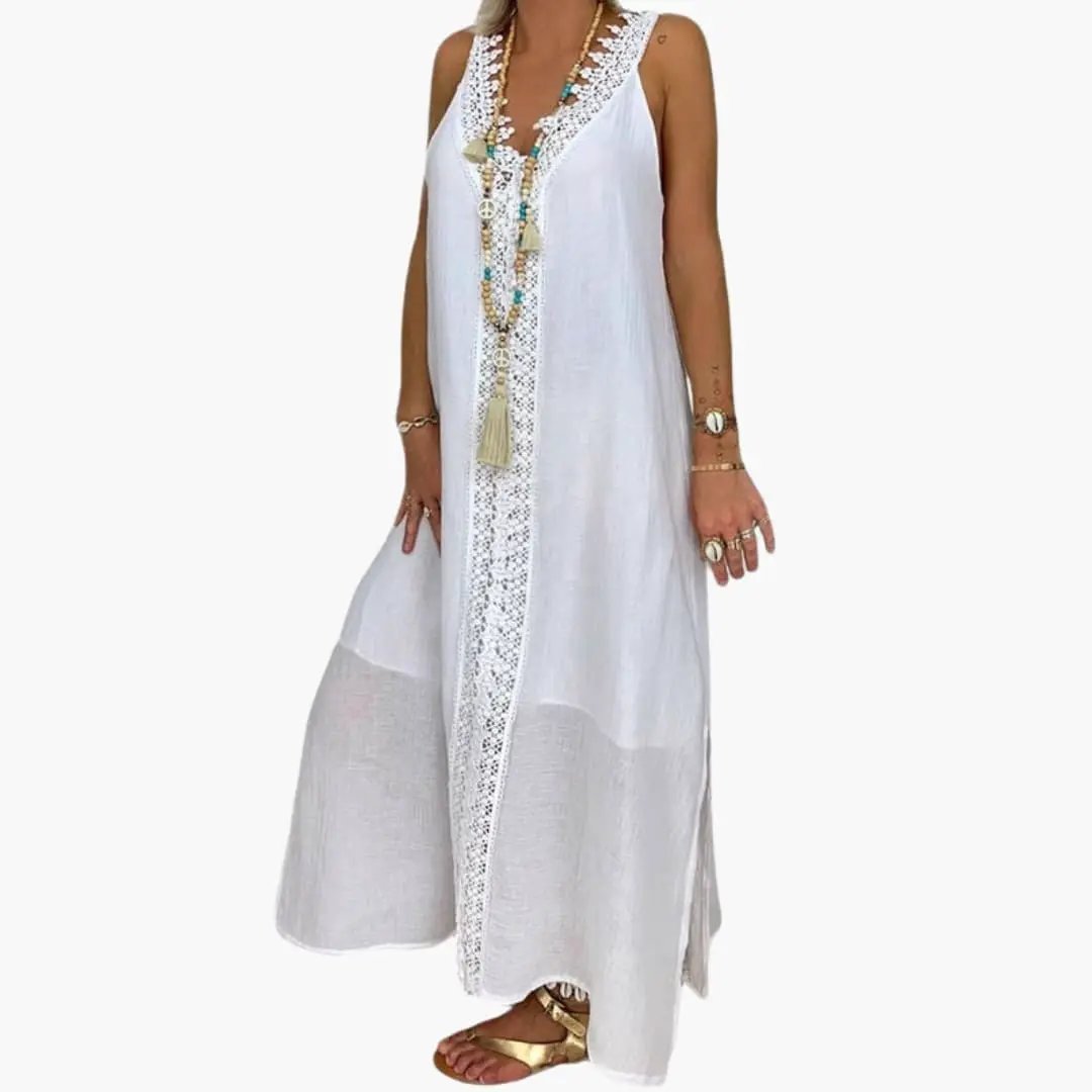 Women's maxi dress in white with lace trim, front lace panel and side slits, ankle-length lightweight fabric.