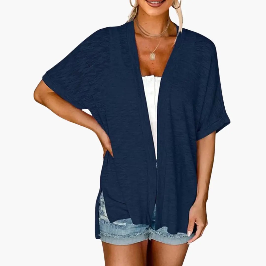 Women's open-front navy cardigan with short sleeves, layered over a white top