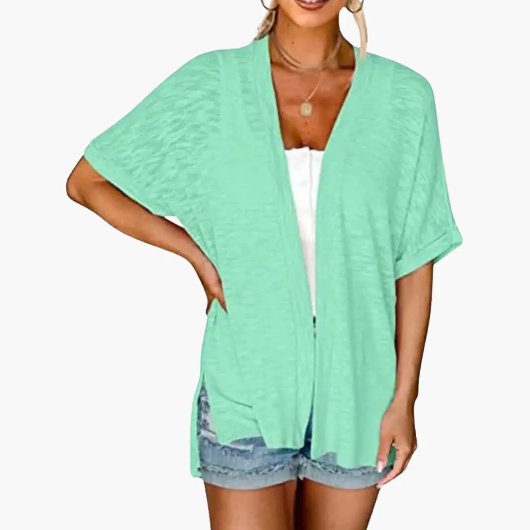 Women's mint green open-front cardigan with short sleeves, layered over white top; lightweight knit layering top