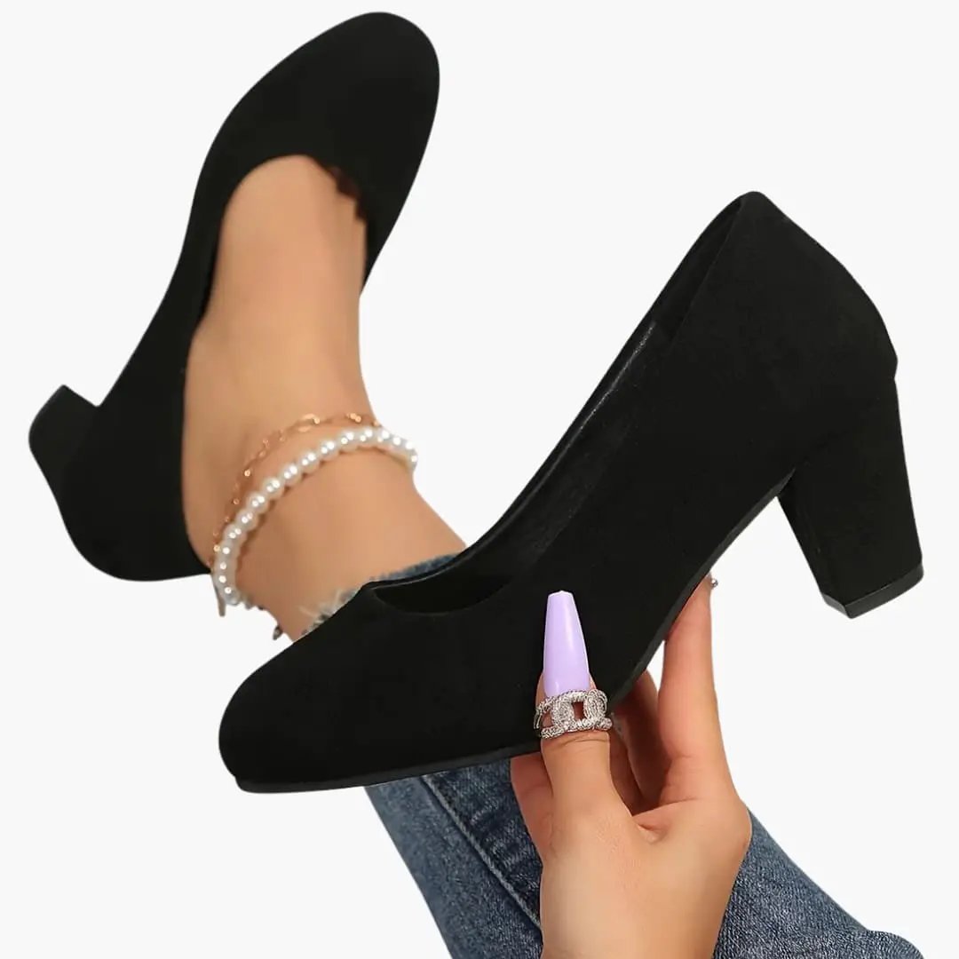 Pair of women's orthopedic heels in black suede with wide toe box and cushioned insole