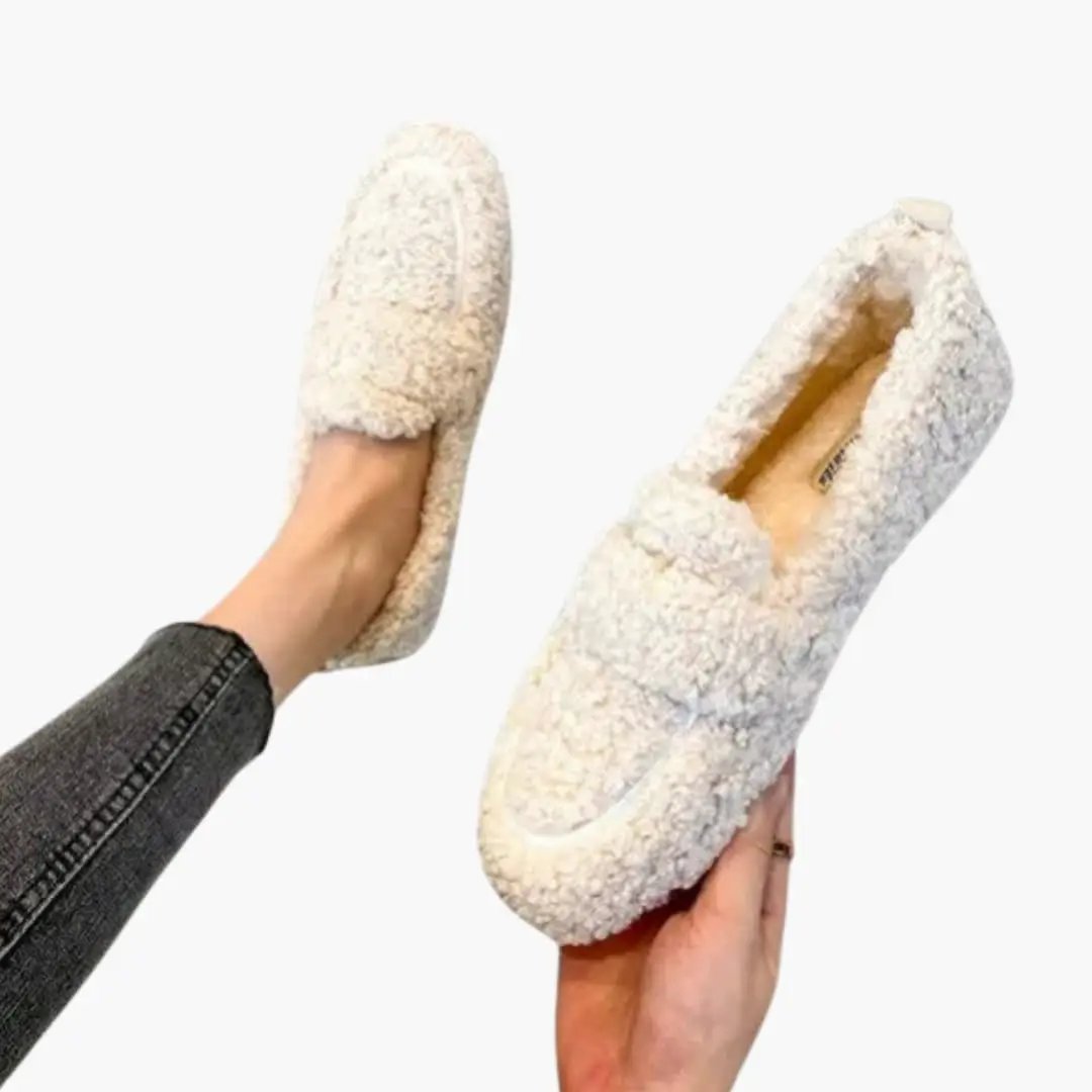 Women's orthopedic slip-on loafers with fluffy white shearling texture and rubber sole
